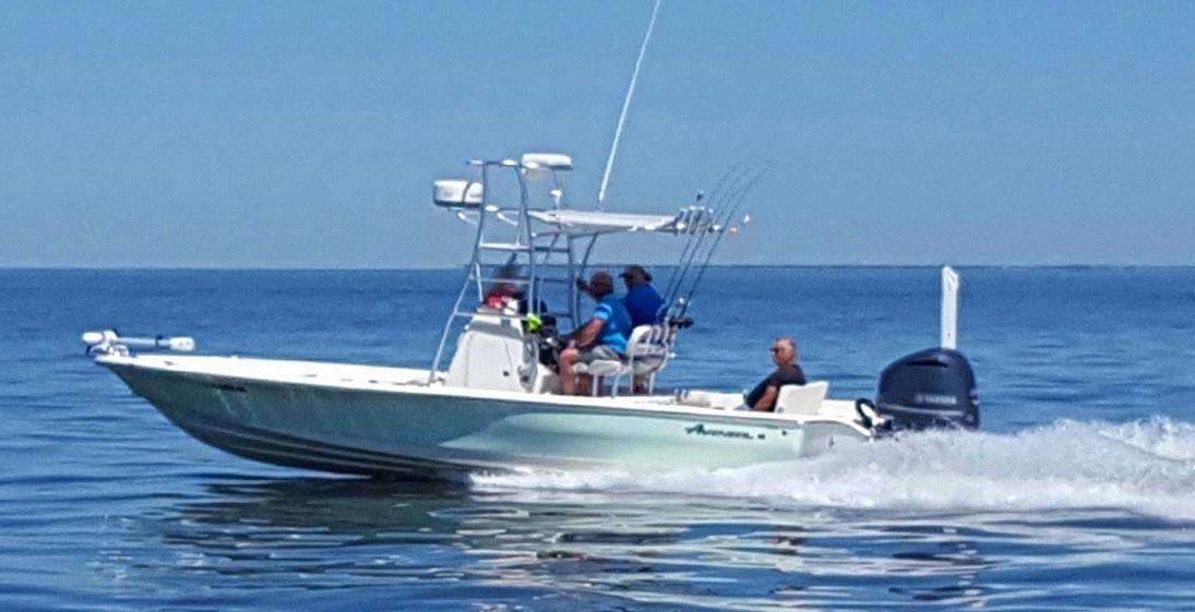 The fishing charter boat speeding by in the shallow waters of mississippi