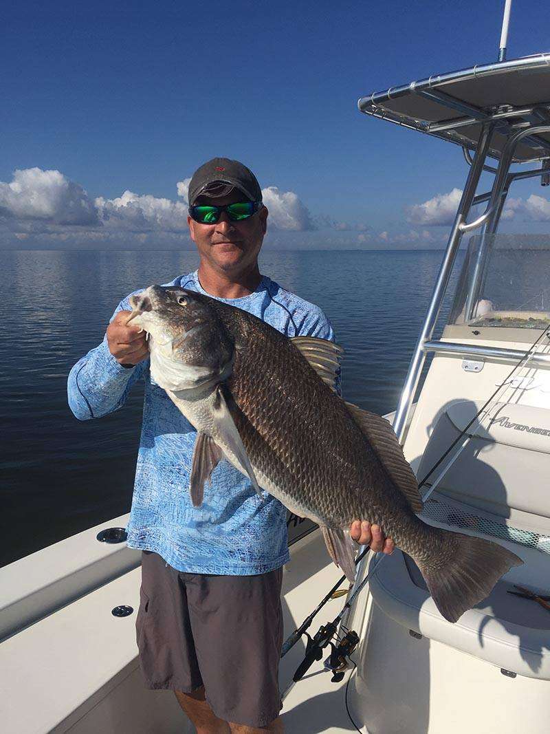 An angler with a large fresh caught fish in Gulfport Ms.